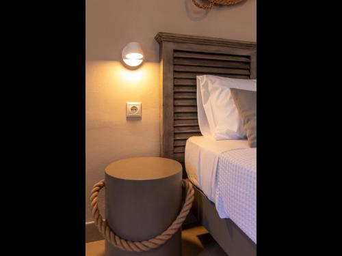 a bedroom with a bed and a night stand next to it at FiscardoStudios in Fiskardho