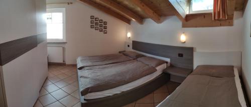 Un dormitorio con una cama grande y una ventana en Cesa Stefi, en Canazei