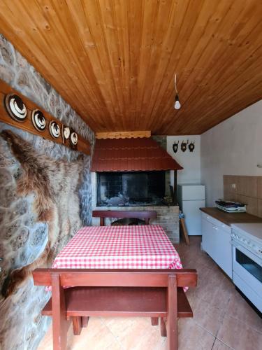 a kitchen with a table and a stone oven at Krka Ivan in Lozovac