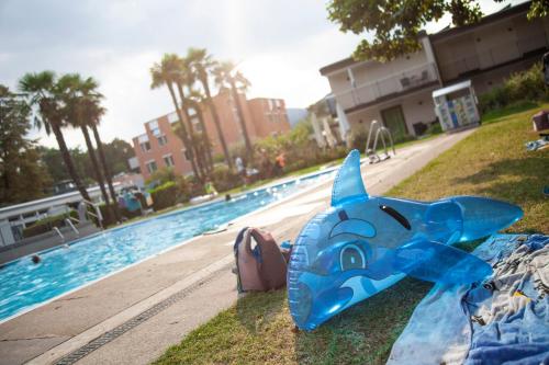 a blue toy airplane sitting next to a swimming pool at Centro Magliaso in Magliaso