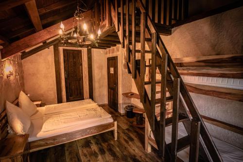 a room with a staircase and a bed in a room at Vaya Casa in Kappelrodeck