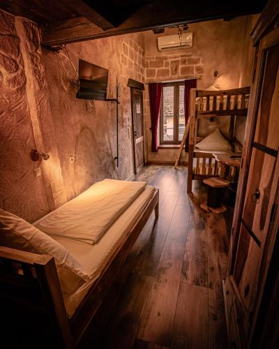 a room with a bed and bunk beds in it at Vaya Casa in Kappelrodeck