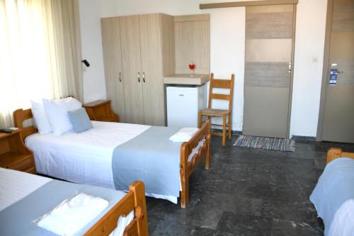 a hotel room with two beds and a kitchen at Klinakis Beach Hotel in Chania Town