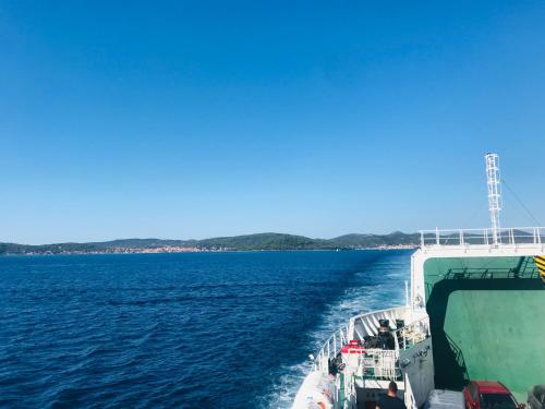 a ferry traveling across a large body of water at Apartments Villa Lora in Kraj