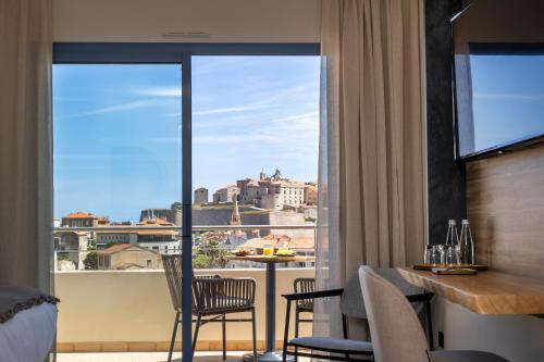 a hotel room with a view of the city at Hotel L'Acquale in Calvi