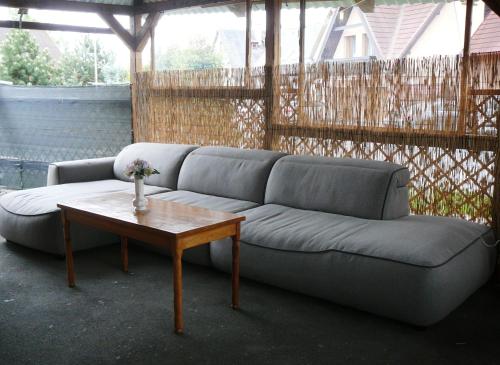a living room with a couch and a coffee table at Chatka Horec in Stará Lesná