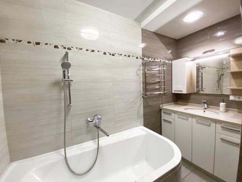 a bathroom with a shower and a bath tub at 2-bedroom apartment Most City Area, Ekaterynoslav square in Dnipro