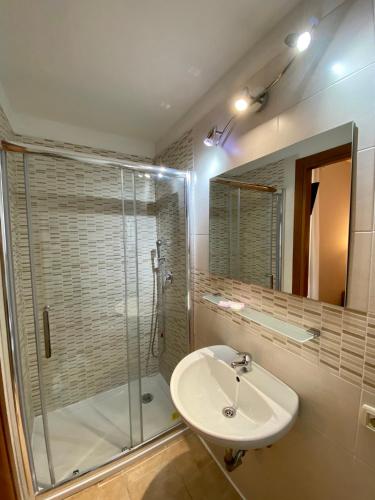 a bathroom with a sink and a glass shower at Hotel Atena in Milan