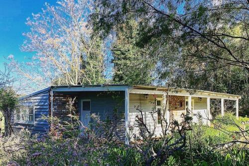 a small house in the middle of a forest at Myrtlemae Farm in Balingup