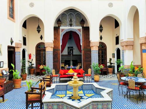 a courtyard with a fountain in the middle of a building at Riad Ahlam in Fès