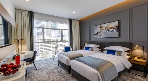 Postel nebo postele na pokoji v ubytování Rose Executive Hotel - DWTC