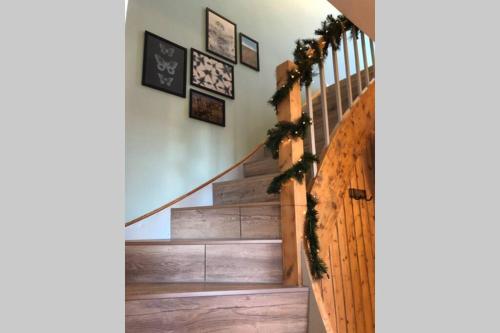a staircase with christmas wreaths on the wall at Harzhaus Ida in Elbingerode