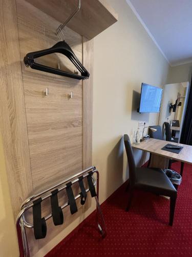 an office with a desk and a chair and a door at Palm Premium Hotel & Apartments in Düsseldorf