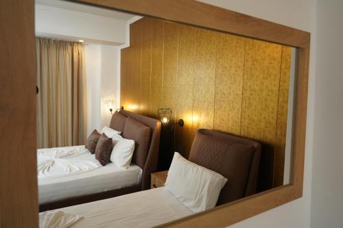 a reflection of a hotel room with two beds at Hotel Monaco & Garden in Golem