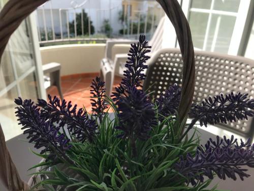 a bouquet of purple flowers sitting on a porch at Innsud in Nardò