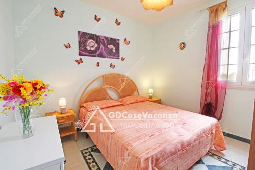 a bedroom with a bed and butterflies on the wall at GD Case Vacanza - Fronte Mare - in Lido Marini
