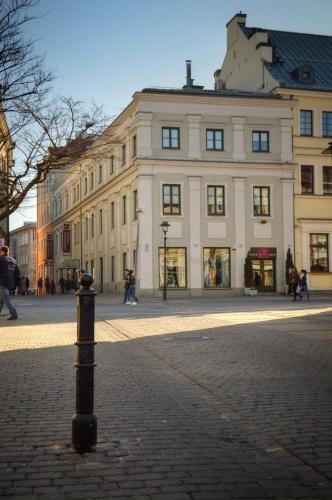 a pole on a street in front of a building at Vanilla Hotel in Lublin