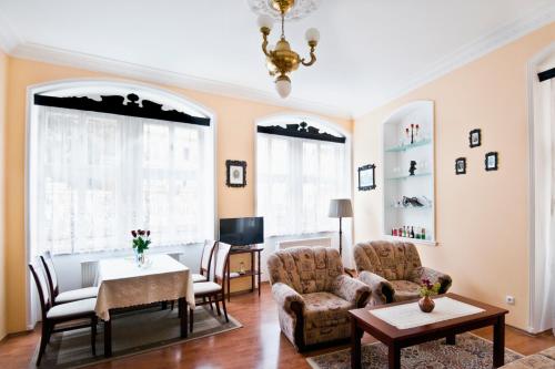 a living room with a table and chairs at Pension Napoleon in Karlovy Vary