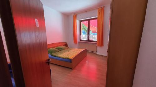 a small bedroom with a bed and a window at Haus Born in Treis-Karden