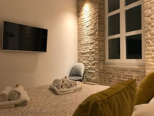 a room with a bed with a chair and a television at Central Park Residence in Split