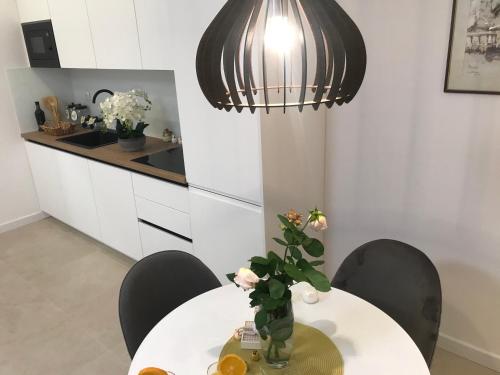 a dining room with a table with a vase of flowers at Central Park Residence in Split