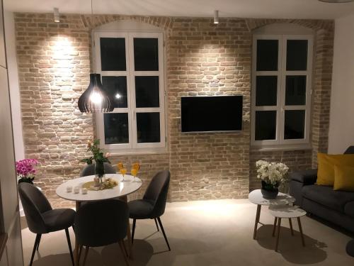 a living room with a brick wall at Central Park Residence in Split
