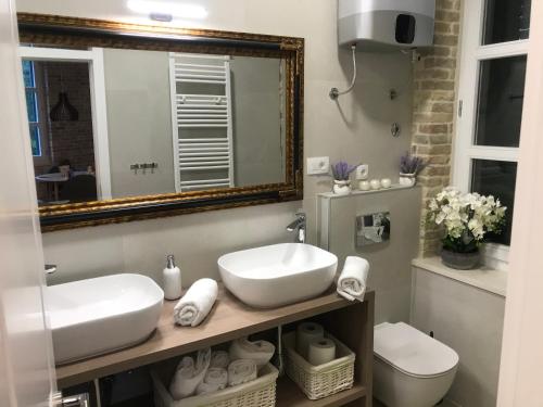 a bathroom with a sink and a mirror and a toilet at Central Park Residence in Split