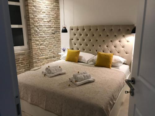 a bedroom with a large bed with towels on it at Central Park Residence in Split