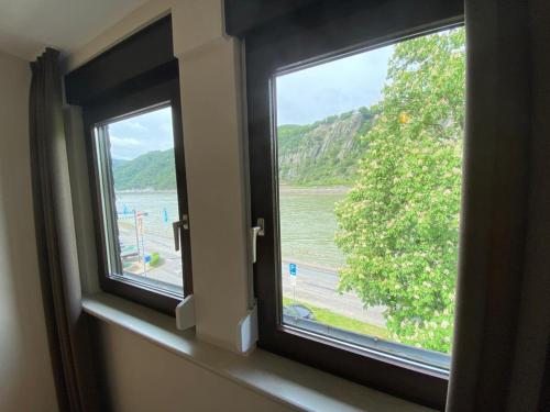 an open window with a view of a body of water at Pension / Ferienwohnungen Scheid in Kestert