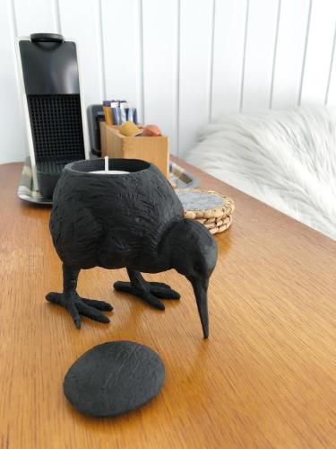a statue of a bird sitting on a table at Beach House For You - Luxe verblijf, 5 min van het strand in Katwijk aan Zee
