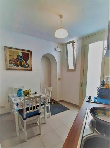 a kitchen and dining room with a table and chairs at A la casa del cavaliere in Positano