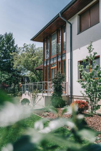 a house with a garden in front of it at Villa Tília Balatongyörök in Balatongyörök