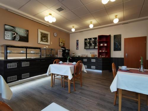 a dining room with tables and chairs in a restaurant at Hotel Mainperle in Wertheim