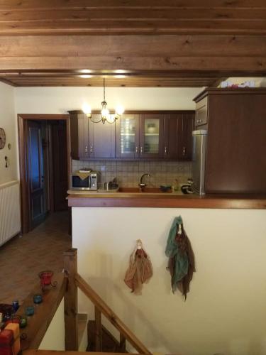 a kitchen with a counter with towels hanging on it at La Casa di Pietra in Karpenision