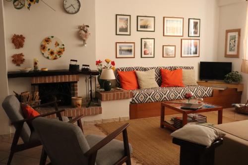 a living room with a couch and a fireplace at Cà 'd Langa B&B in Treiso