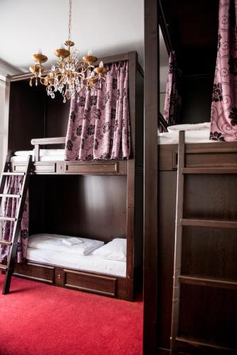 two bunk beds with a ladder in a room at Vienna Boutique - Premium Hostel in Vienna