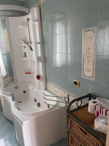 a bathroom with a tub and a shower in it at B&B Alba in SantʼAnastasia
