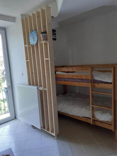 a room with bunk beds in a room with a window at Studio en plein centre ville - 2 à 4 personnes in Tence