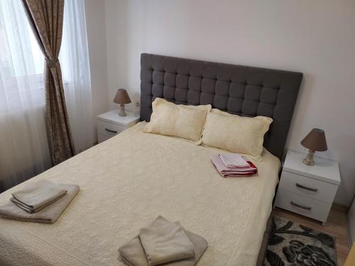 a bedroom with a large bed with two night stands at Mona in Mamaia