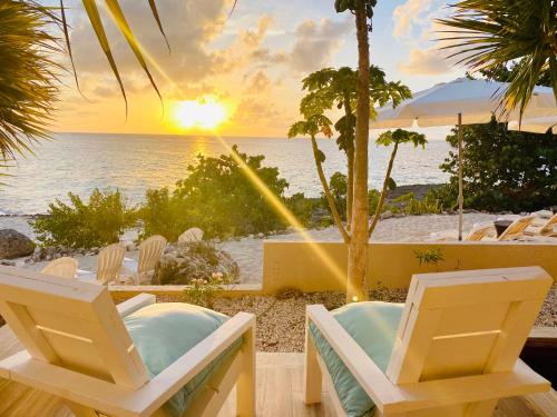 a view of a beach with chairs and the ocean at Sandcastle Villa in Crocus Hill