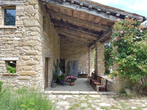 a stone building with a patio with benches at TERRALUNA Villa Vacanze San Leo - San Marino in San Leo
