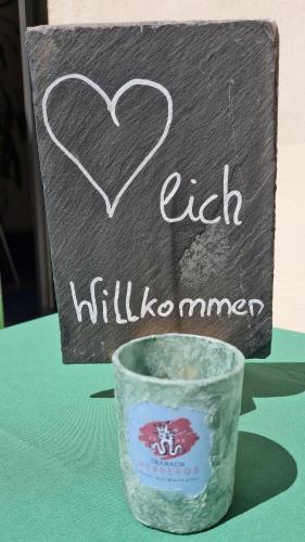 a sign with a heart and a cup on a table at Hotel Cranach-Herberge City Centre in Lutherstadt Wittenberg