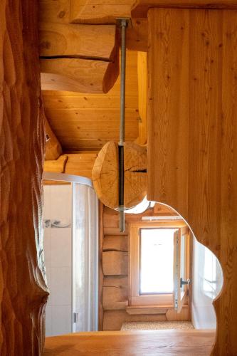 a room with a wooden ceiling and a window at Le Gite de Briey - à 7 minutes de Vercorin in Chalais