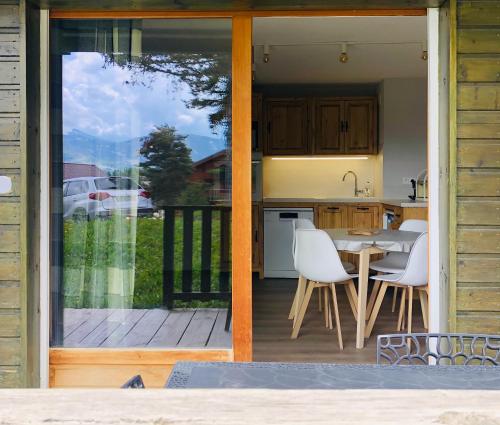 eine Küche mit einem Tisch und Stühlen auf einer Terrasse in der Unterkunft Le Chalet d'Aurouze 103, Appartement 6 personnes - la Joue du Loup in La Joue du Loup