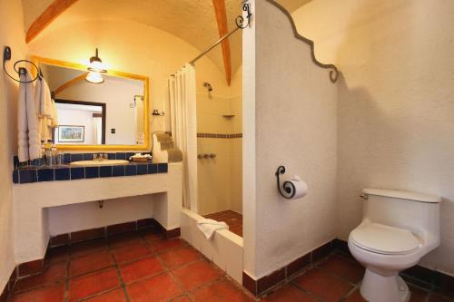 a bathroom with a toilet and a sink and a shower at Villa Colonial in Antigua Guatemala