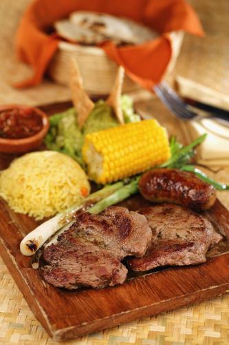 a plate of food with meat and vegetables on a table at Villa Colonial in Antigua Guatemala