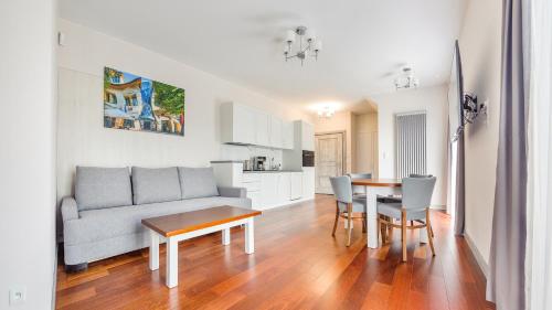 a living room with a couch and a table at Apartamenty Sopockie Błonie in Sopot