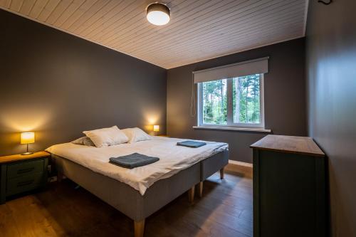 a bedroom with a bed with two towels on it at Jõeranna Lodge in Paope