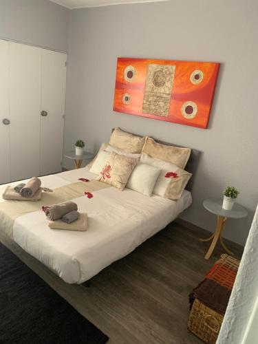 a bedroom with a large white bed with pillows at Sweet Home Albufeira in Albufeira