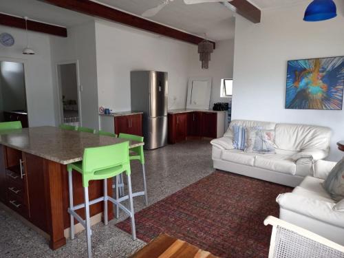 a kitchen and living room with a couch and a table at Ocean Rush in Zinkwazi Beach